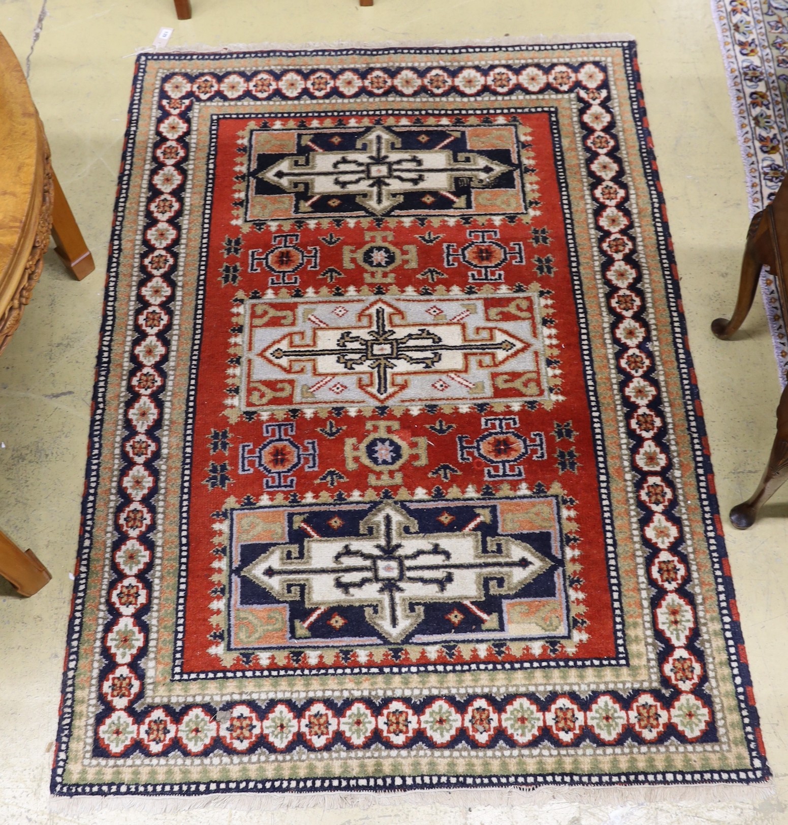 A Caucasian style brick red ground rug, 180 x 128cm